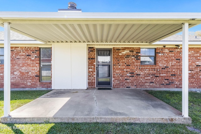 exterior space with a patio area and brick siding