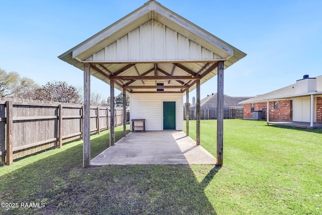 view of yard with a gazebo, a carport, a fenced backyard, and a patio area