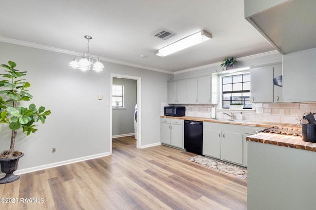 kitchen featuring visible vents, backsplash, a healthy amount of sunlight, black appliances, and wood counters