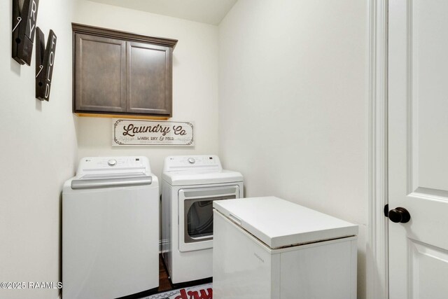 clothes washing area featuring cabinet space and washing machine and dryer