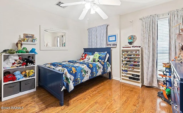 bedroom featuring visible vents, ceiling fan, and wood finished floors