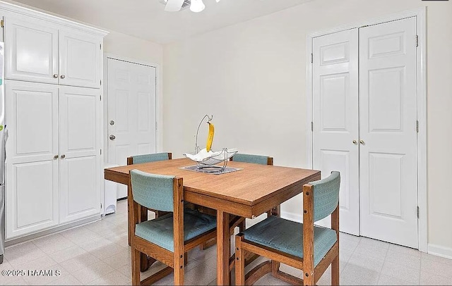 dining room with baseboards and light floors