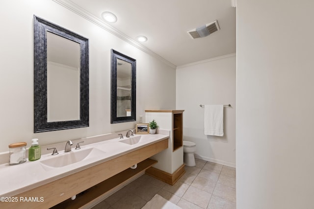 bathroom featuring crown molding, toilet, visible vents, and a sink