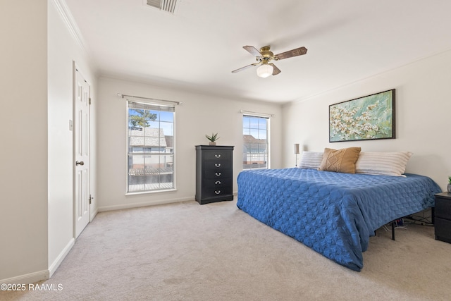 bedroom featuring visible vents, baseboards, ornamental molding, carpet flooring, and a ceiling fan