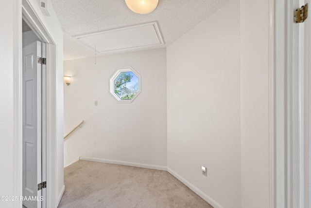 interior space featuring attic access, visible vents, baseboards, and a textured ceiling