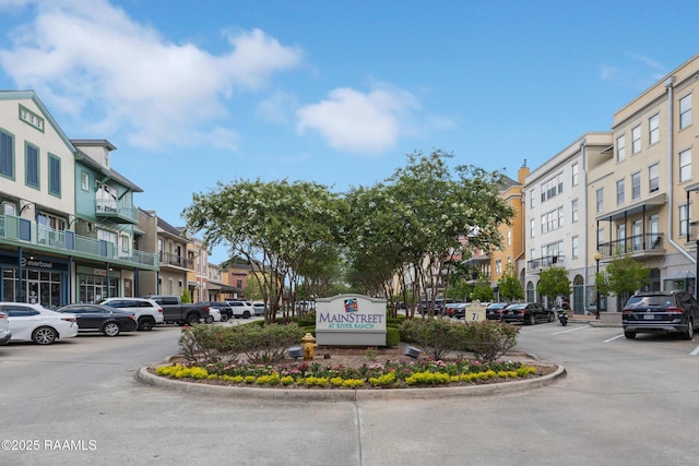 community sign featuring uncovered parking