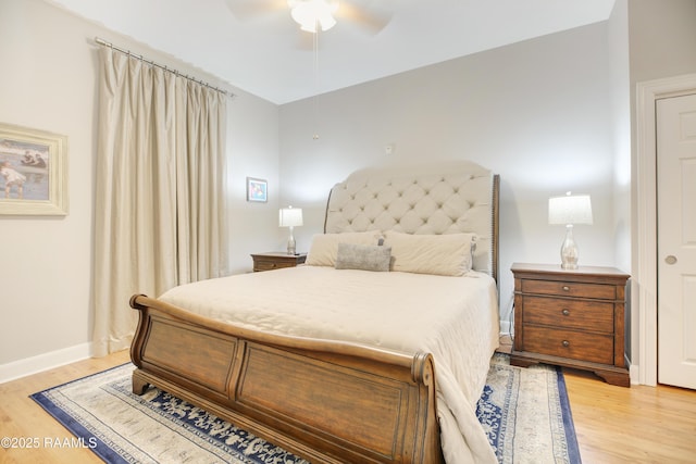 bedroom featuring ceiling fan, baseboards, and light wood-style flooring