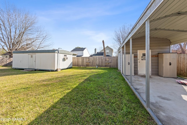 view of yard with an outbuilding, a shed, and a fenced backyard