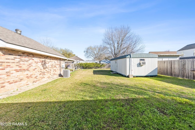 view of yard with an outdoor structure, central air condition unit, a fenced backyard, and a shed