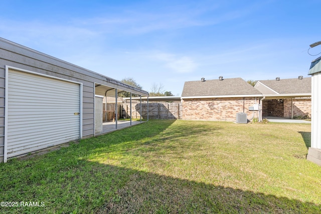 view of yard with a patio area, central AC unit, and fence