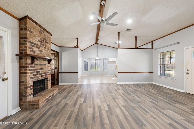 unfurnished living room with plenty of natural light, a fireplace, and wood finished floors