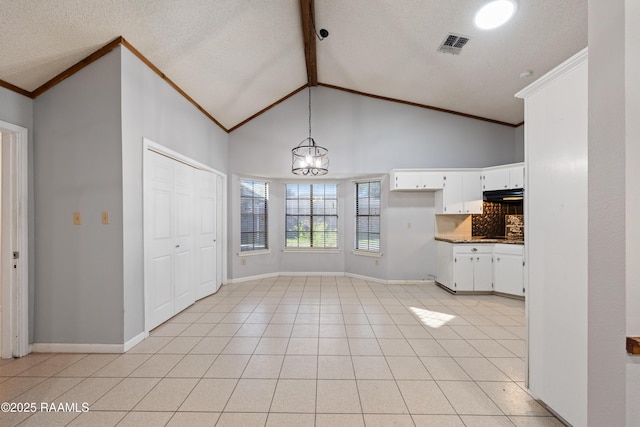 unfurnished dining area featuring crown molding, light tile patterned floors, baseboards, and beam ceiling