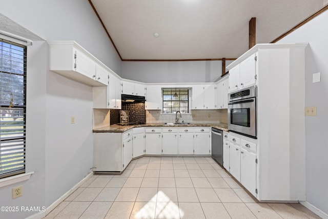 kitchen with a sink, decorative backsplash, ornamental molding, stainless steel appliances, and white cabinetry