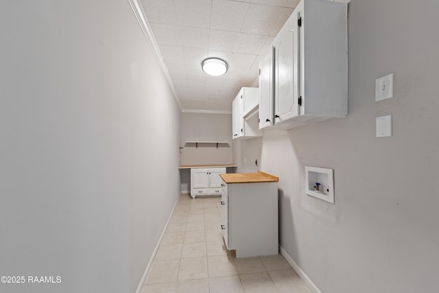 laundry area with washer hookup, crown molding, cabinet space, and baseboards