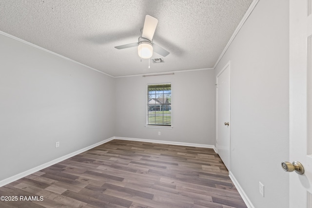 empty room with a ceiling fan, crown molding, wood finished floors, and baseboards