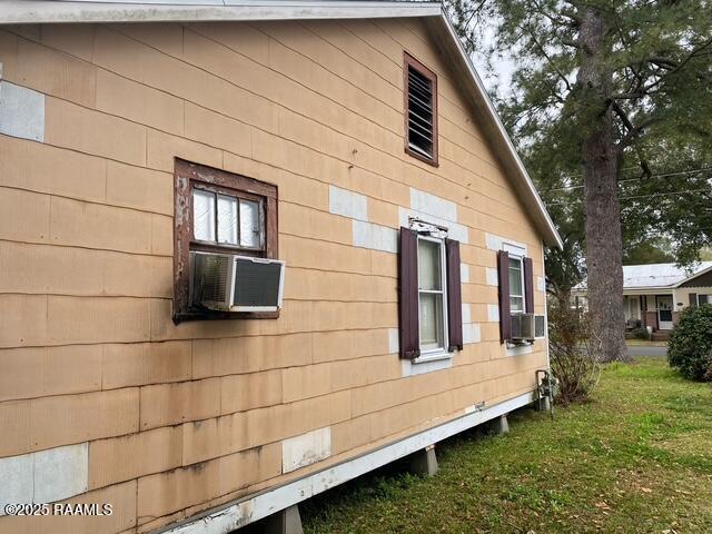 view of side of property with cooling unit