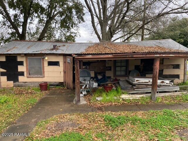 back of house with metal roof