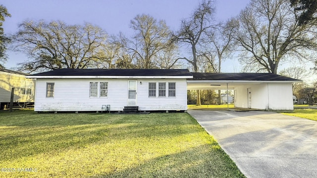 view of front of house with driveway, a carport, a front lawn, and entry steps