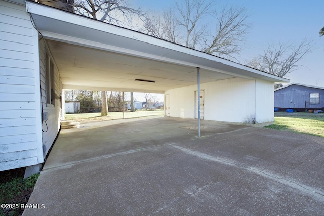 view of parking with an attached carport and driveway