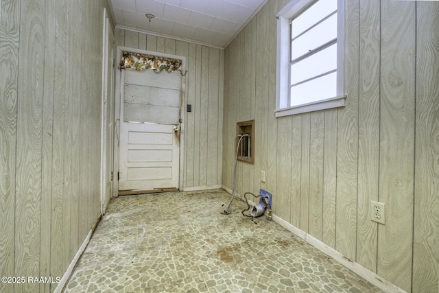 laundry room featuring wood walls