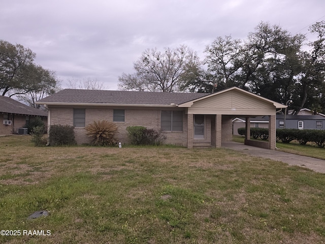 ranch-style house with an attached carport, a front yard, cooling unit, driveway, and brick siding