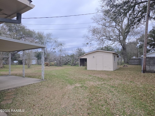 view of yard featuring an outdoor structure, a shed, and fence