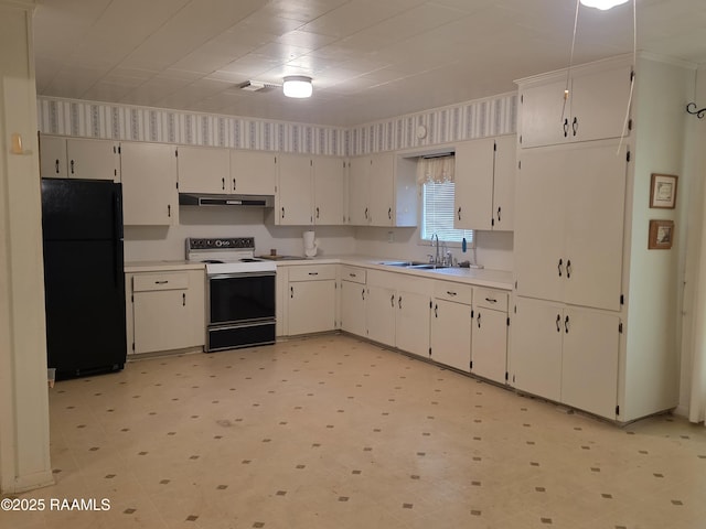 kitchen with light floors, freestanding refrigerator, a sink, under cabinet range hood, and white range with electric stovetop