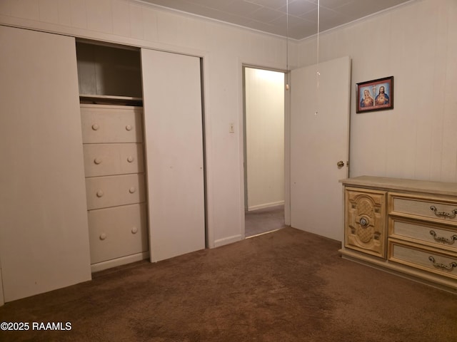 unfurnished bedroom featuring a closet, carpet flooring, and ornamental molding