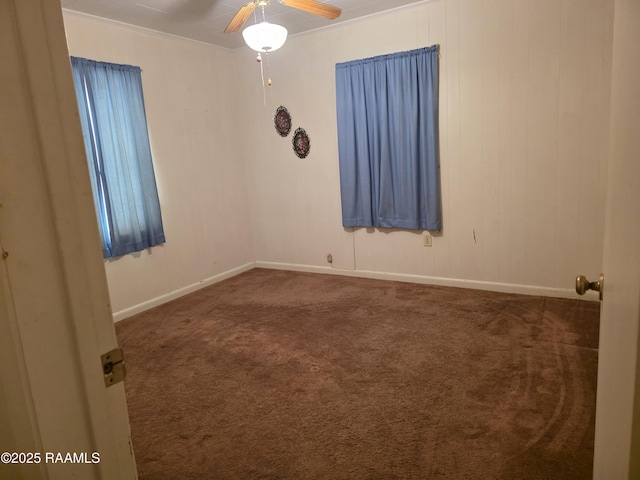 unfurnished room with a ceiling fan, baseboards, and carpet floors