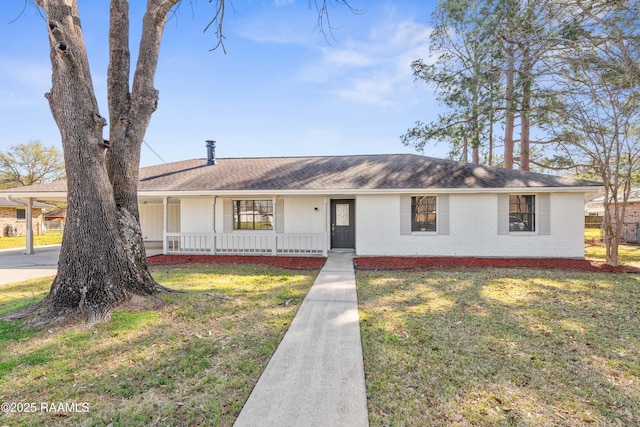 ranch-style home with a front yard, brick siding, covered porch, and roof with shingles