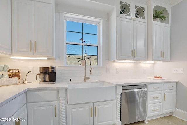 kitchen featuring a sink, dishwasher, and white cabinets