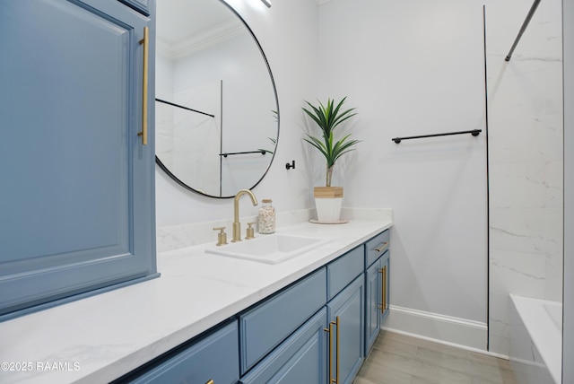 full bathroom featuring vanity, baseboards, a bathing tub, ornamental molding, and walk in shower