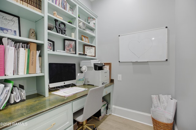 home office featuring light wood-type flooring and baseboards