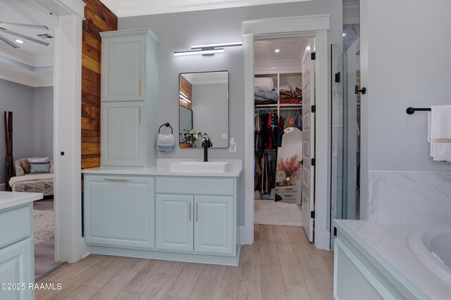 bathroom with vanity, a stall shower, and crown molding