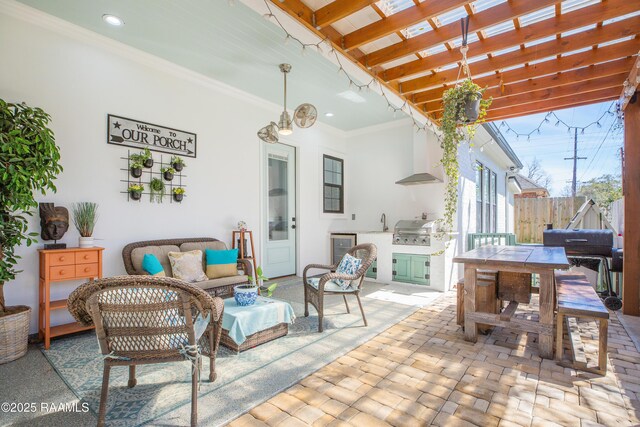 view of patio / terrace featuring an outdoor kitchen, fence, outdoor lounge area, and a grill