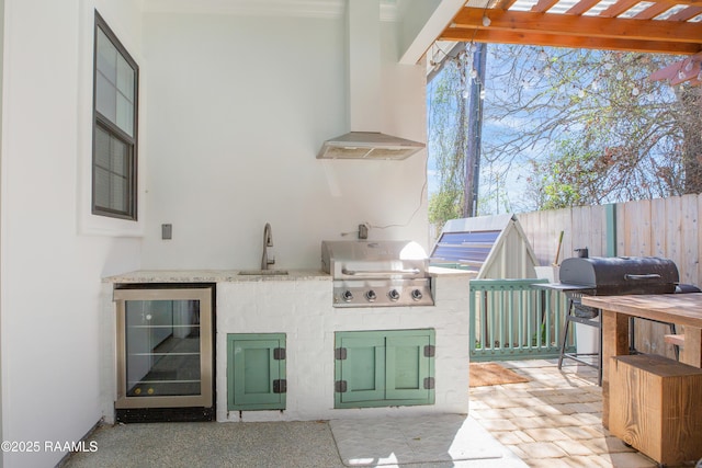 view of patio / terrace with fence, wine cooler, area for grilling, a grill, and a pergola