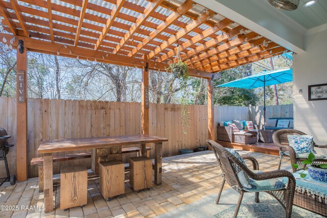 view of patio featuring outdoor lounge area, fence, and a pergola