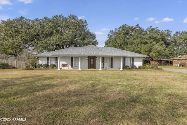 ranch-style house featuring a front lawn, fence, and stucco siding