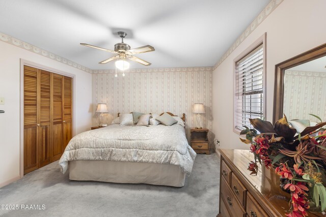 bedroom with a closet, carpet floors, a ceiling fan, and wallpapered walls