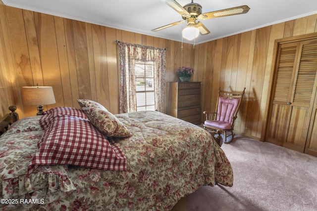 bedroom featuring wooden walls, a ceiling fan, carpet floors, and ornamental molding