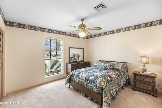 bedroom featuring a closet, visible vents, ceiling fan, and carpet