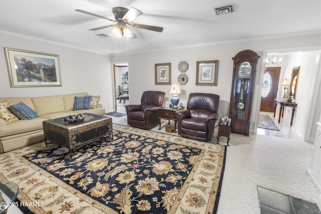 carpeted living area with visible vents, crown molding, and ceiling fan