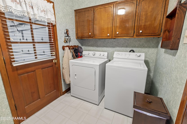 laundry room featuring cabinet space, independent washer and dryer, and wallpapered walls