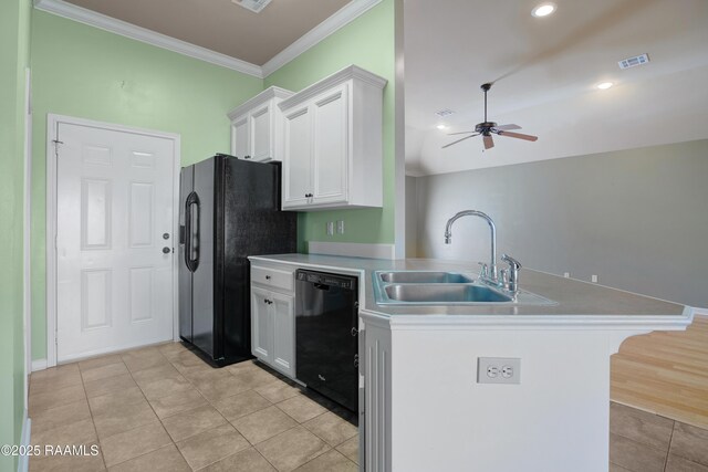 kitchen with light tile patterned floors, a peninsula, a sink, black appliances, and white cabinetry