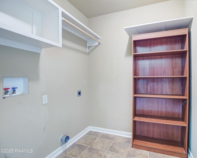 laundry room featuring tile patterned floors, hookup for a washing machine, hookup for an electric dryer, and baseboards