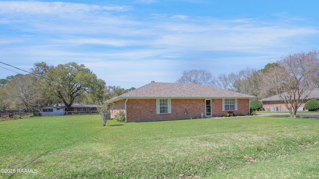 ranch-style home with a front lawn and brick siding