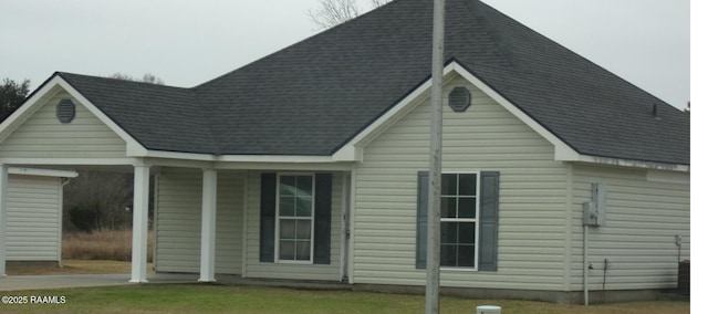 exterior space featuring a shingled roof