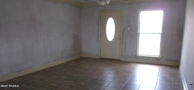 entryway featuring baseboards and ceiling fan