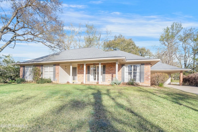 ranch-style home featuring brick siding, a shingled roof, a front lawn, a carport, and driveway