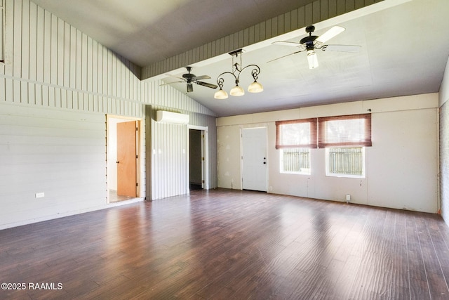 interior space featuring vaulted ceiling, ceiling fan with notable chandelier, a wall mounted AC, and wood finished floors